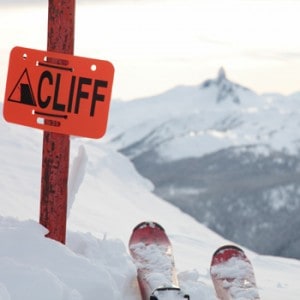 A pair of skis on the edge of a dangerous cliff in Whistler, British Columbia.