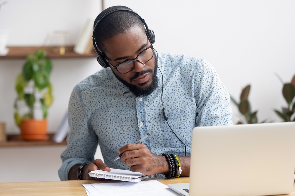 African American man studying using laptop