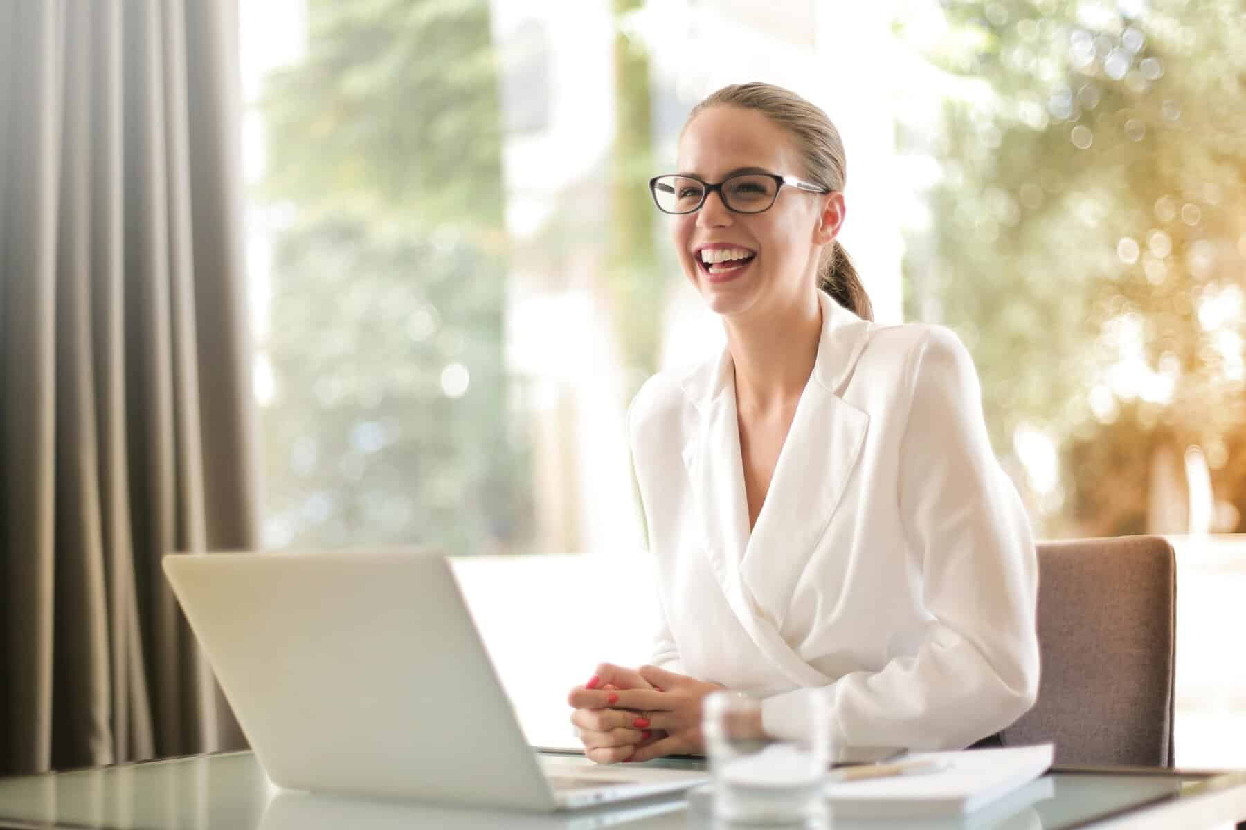 woman smiling at her desk