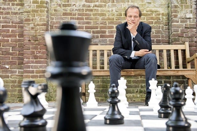 Man looking at chess game