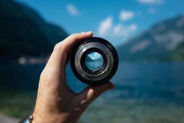 Hand holding camera lens