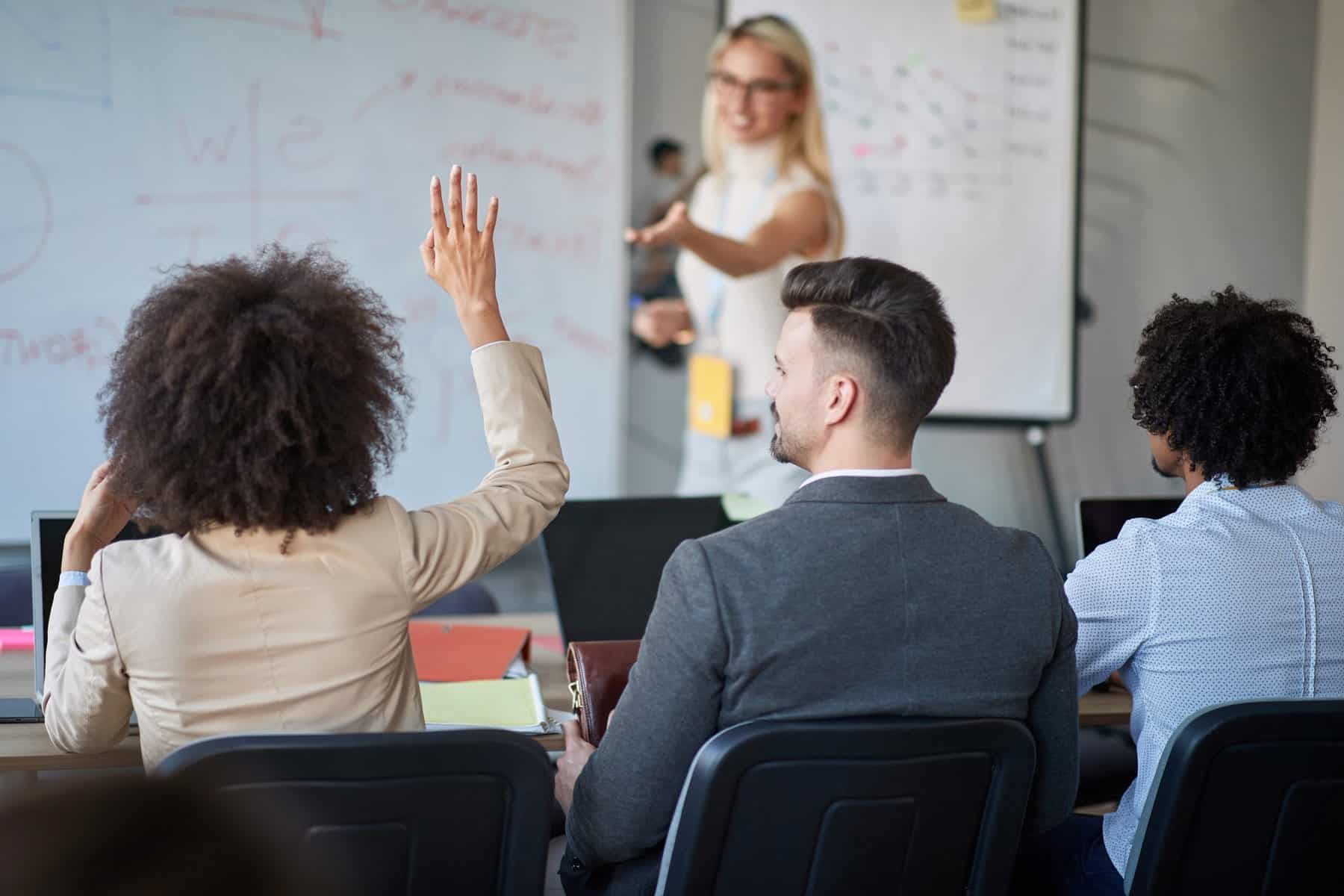 woman raising her hand in velociteach classroom